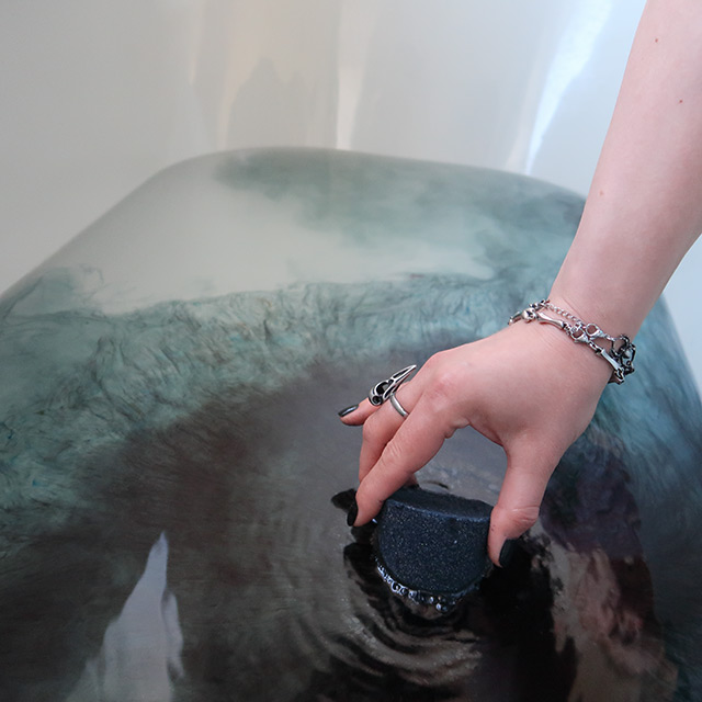 Dissolving a black bath bomb from Hexbomb